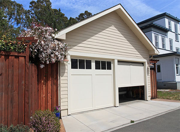 A well-maintained garage door opening smoothly, indicating proper balance, lubrication, and functional components for reliable operation.